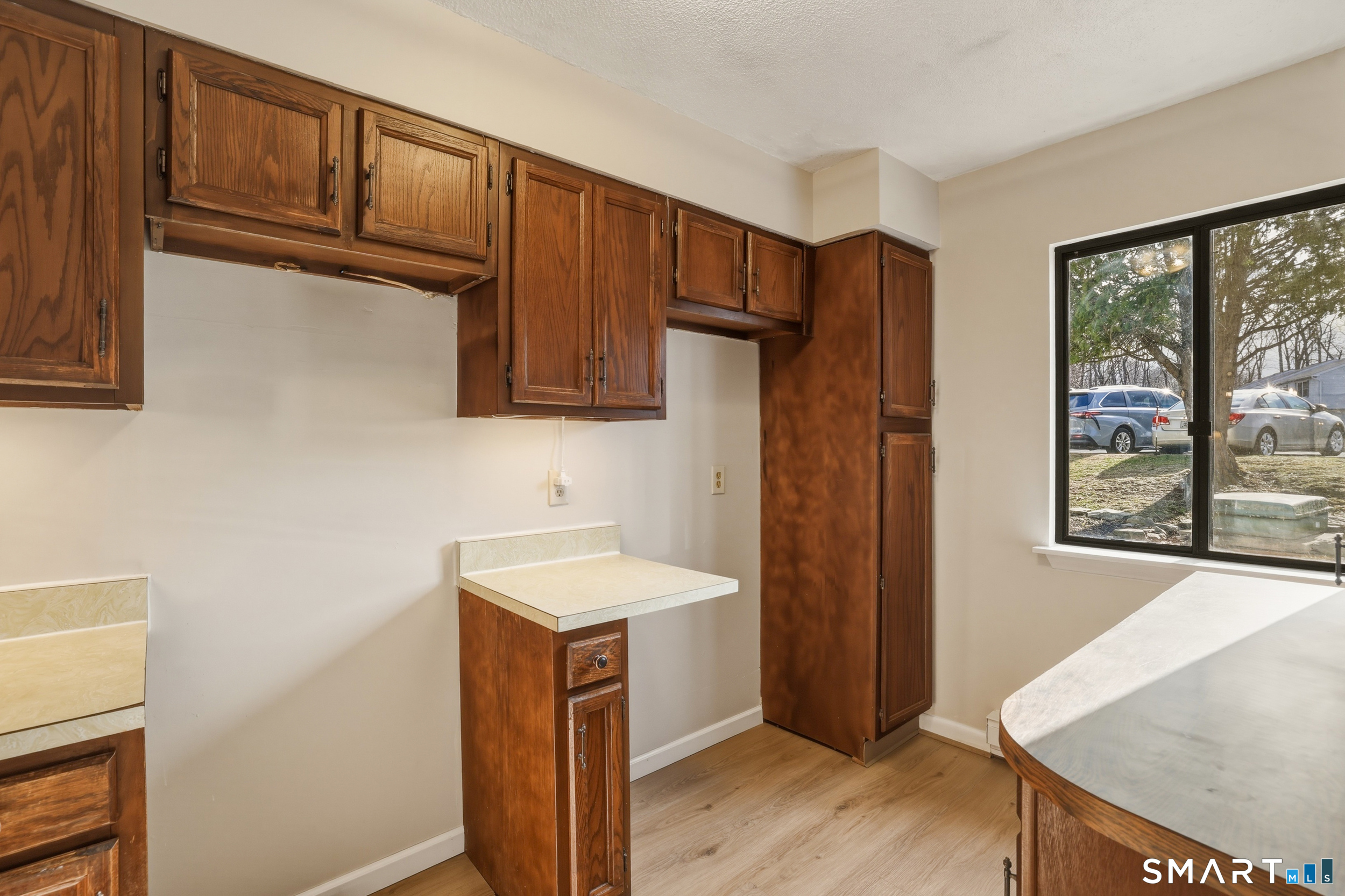 412 South Main Street, Unit 15 Plymouth, CT 06786 - Photo 8 of 28 a kitchen with stainless steel appliances granite countertop a refrigerator a sink dishwasher and wooden cabinets with wooden floor