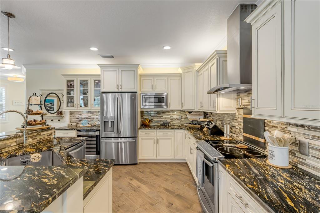 123 Marina Bay Drive New Smyrna Beach, FL 32169 - Photo 24 of 84 a kitchen with granite countertop a stove sink and refrigerator