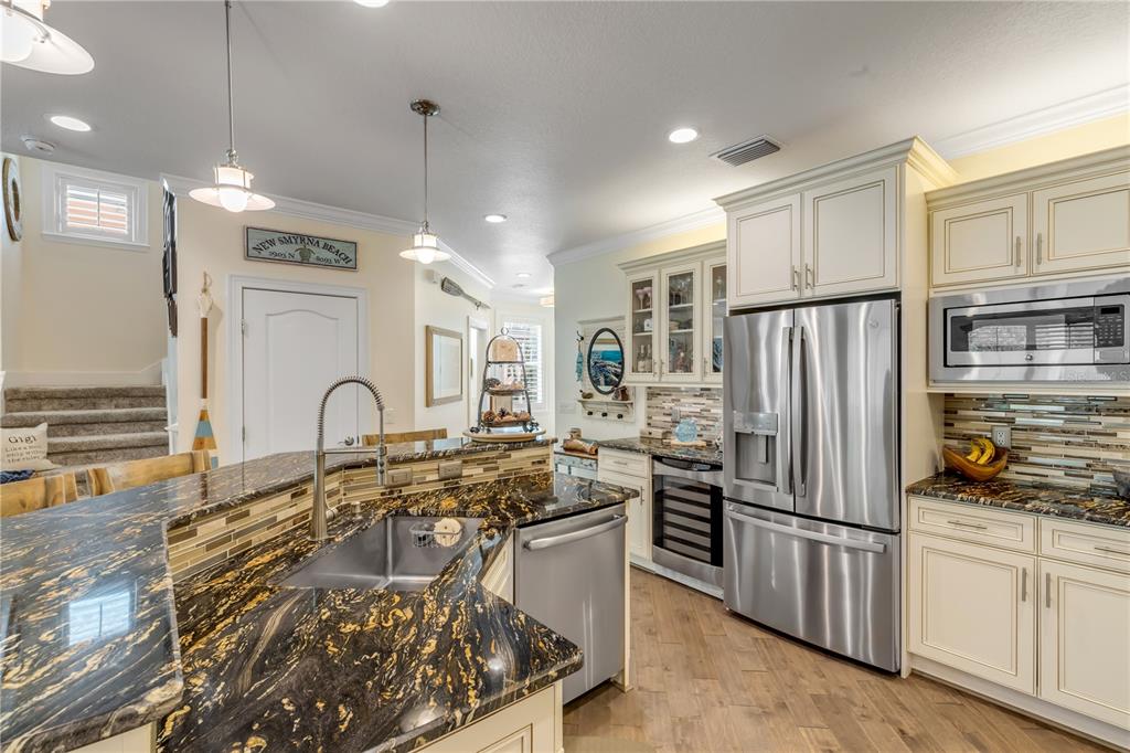 123 Marina Bay Drive New Smyrna Beach, FL 32169 - Photo 25 of 84 a kitchen with stainless steel appliances granite countertop a refrigerator and a stove top oven