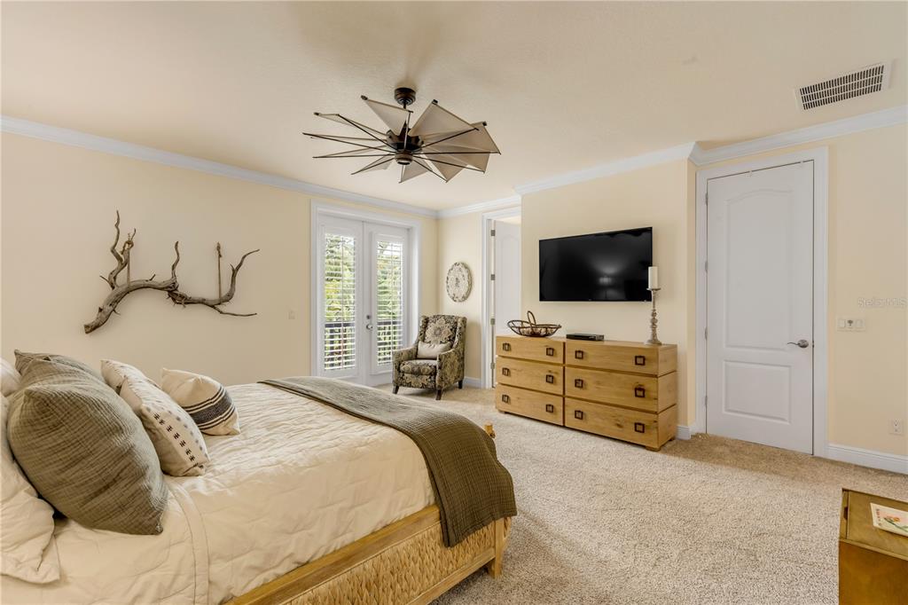 123 Marina Bay Drive New Smyrna Beach, FL 32169 - Photo 36 of 84 a bedroom with a bed and a flat screen tv