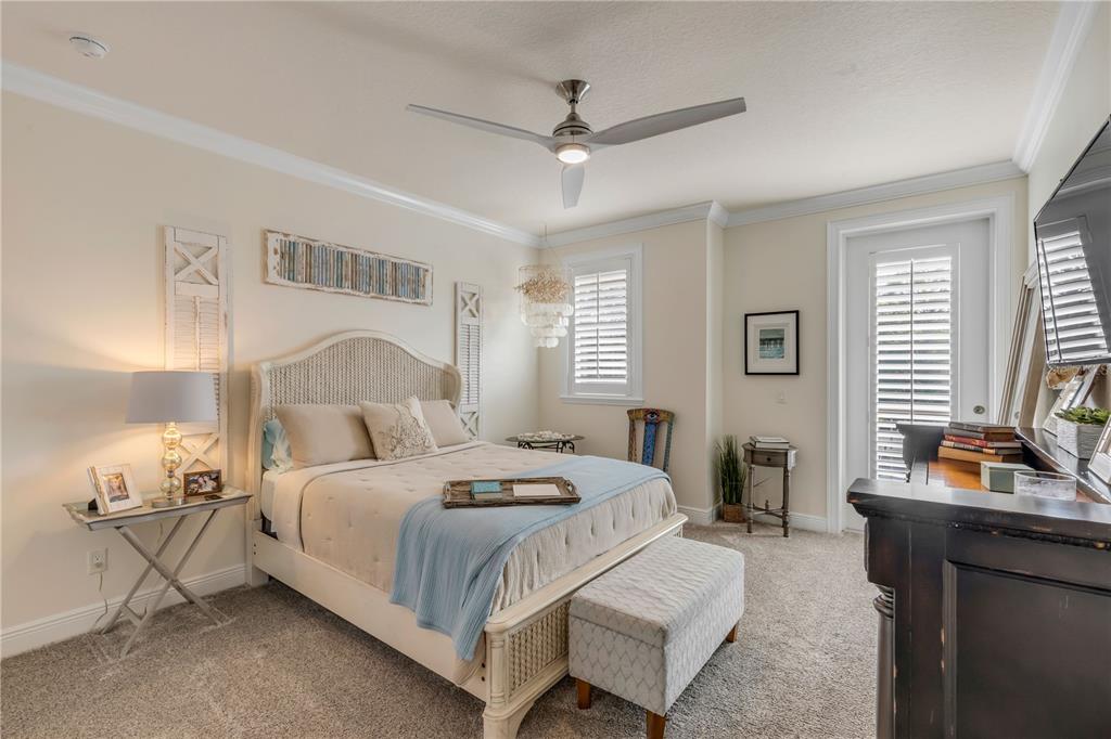 123 Marina Bay Drive New Smyrna Beach, FL 32169 - Photo 49 of 84 a bedroom with a bed and a chandelier