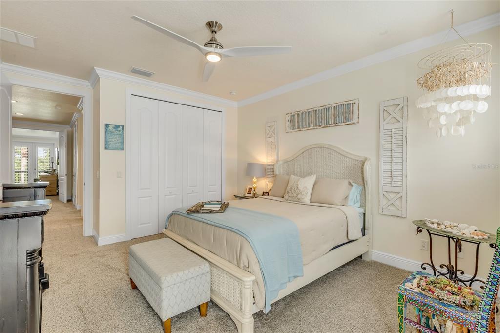 123 Marina Bay Drive New Smyrna Beach, FL 32169 - Photo 51 of 84 a bedroom with a bed a chandelier and a mirror