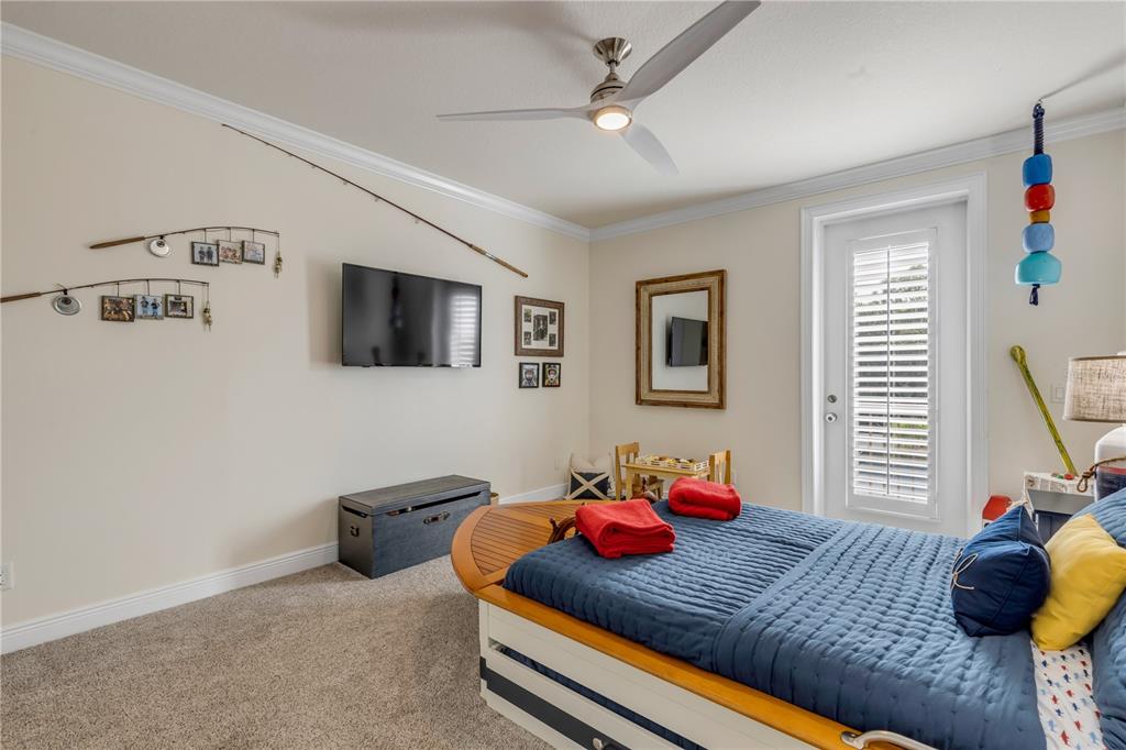 123 Marina Bay Drive New Smyrna Beach, FL 32169 - Photo 53 of 84 a bedroom with a bed and a flat tv screen