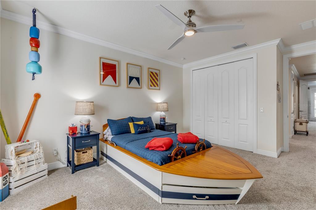 123 Marina Bay Drive New Smyrna Beach, FL 32169 - Photo 54 of 84 a bedroom with furniture and a chandelier