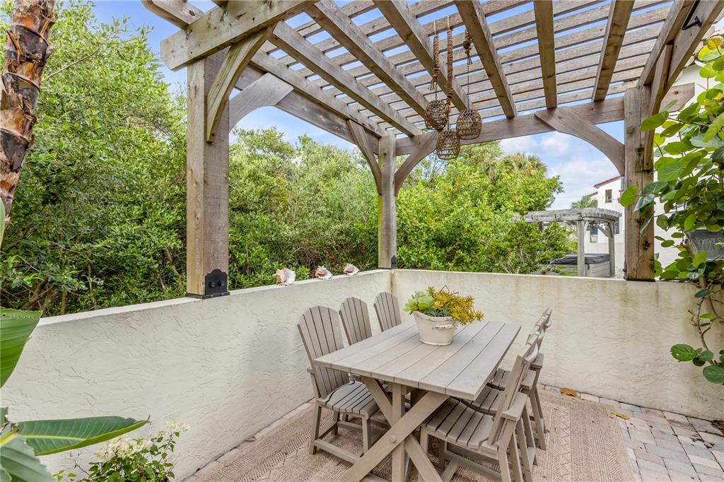 123 Marina Bay Drive New Smyrna Beach, FL 32169 - Photo 66 of 84 a view of a patio with table and chairs and potted plants
