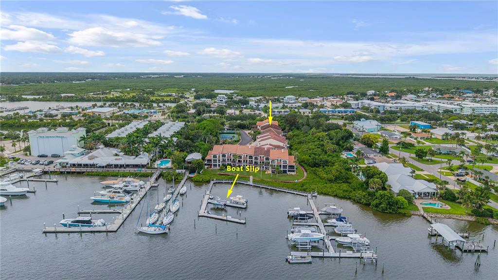 123 Marina Bay Drive New Smyrna Beach, FL 32169 - Photo 74 of 84 an aerial view of residential building with outdoor space and lake view in back