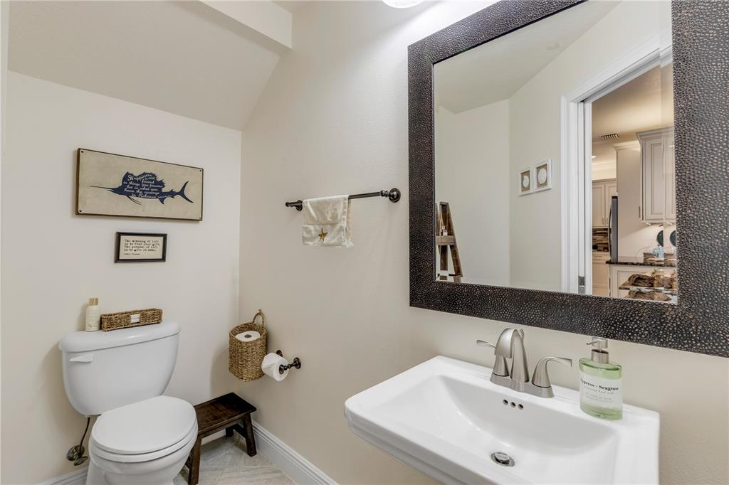 123 Marina Bay Drive New Smyrna Beach, FL 32169 - Photo 10 of 84 a bathroom with a toilet a sink and a mirror