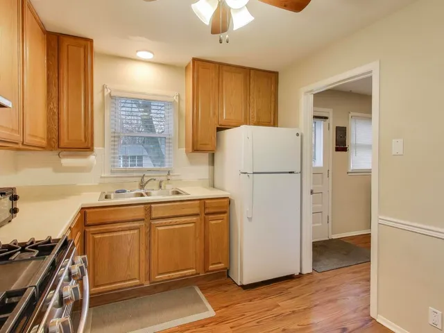 a utility room with wooden floor washer and dryer
