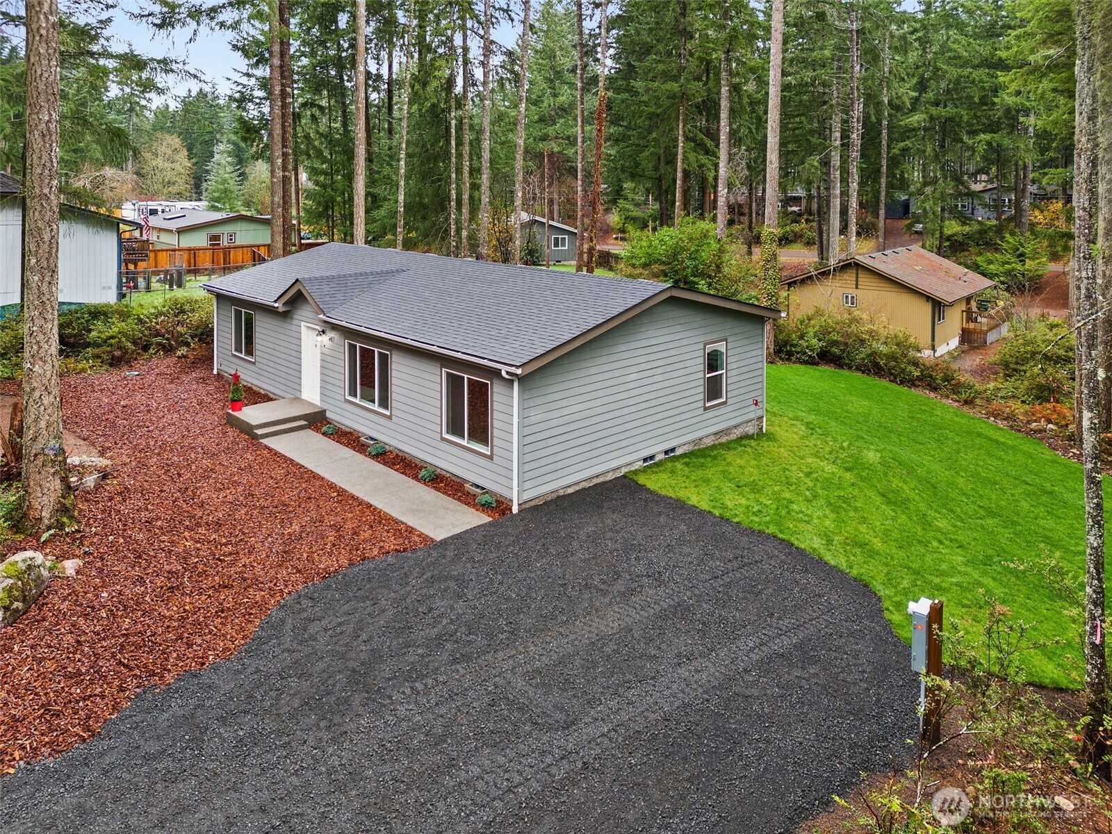 a aerial view of a house with yard and green space