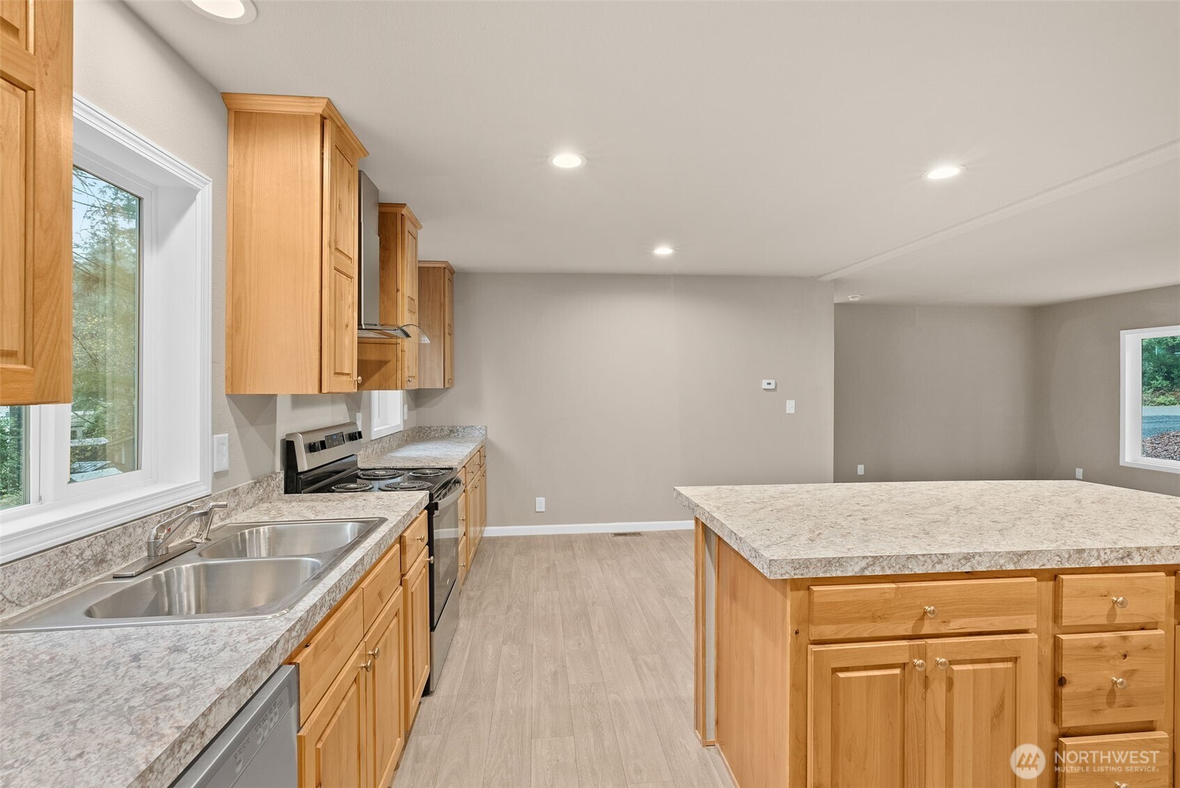 141 East Dalkeith Road Shelton, WA 98584 - Photo 12 of 38 a kitchen with granite countertop a sink and a wooden floor