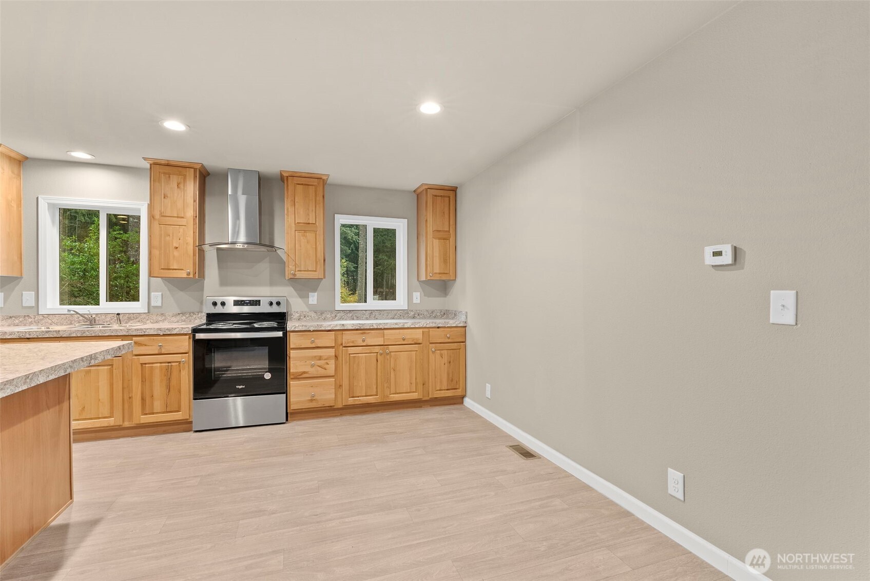 141 East Dalkeith Road Shelton, WA 98584 - Photo 13 of 38 a large kitchen with granite countertop a stove top oven sink and cabinets