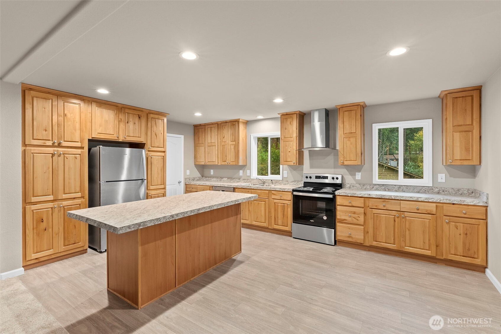 141 East Dalkeith Road Shelton, WA 98584 - Photo 9 of 38 a large kitchen with granite countertop a large counter top stainless steel appliances and windows