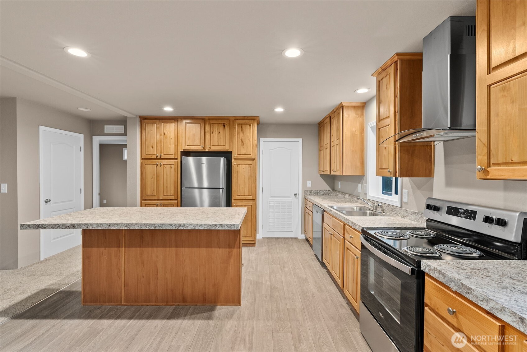 141 East Dalkeith Road Shelton, WA 98584 - Photo 10 of 38 a kitchen with stainless steel appliances granite countertop wooden cabinets a stove top oven a sink and dishwasher next to a window