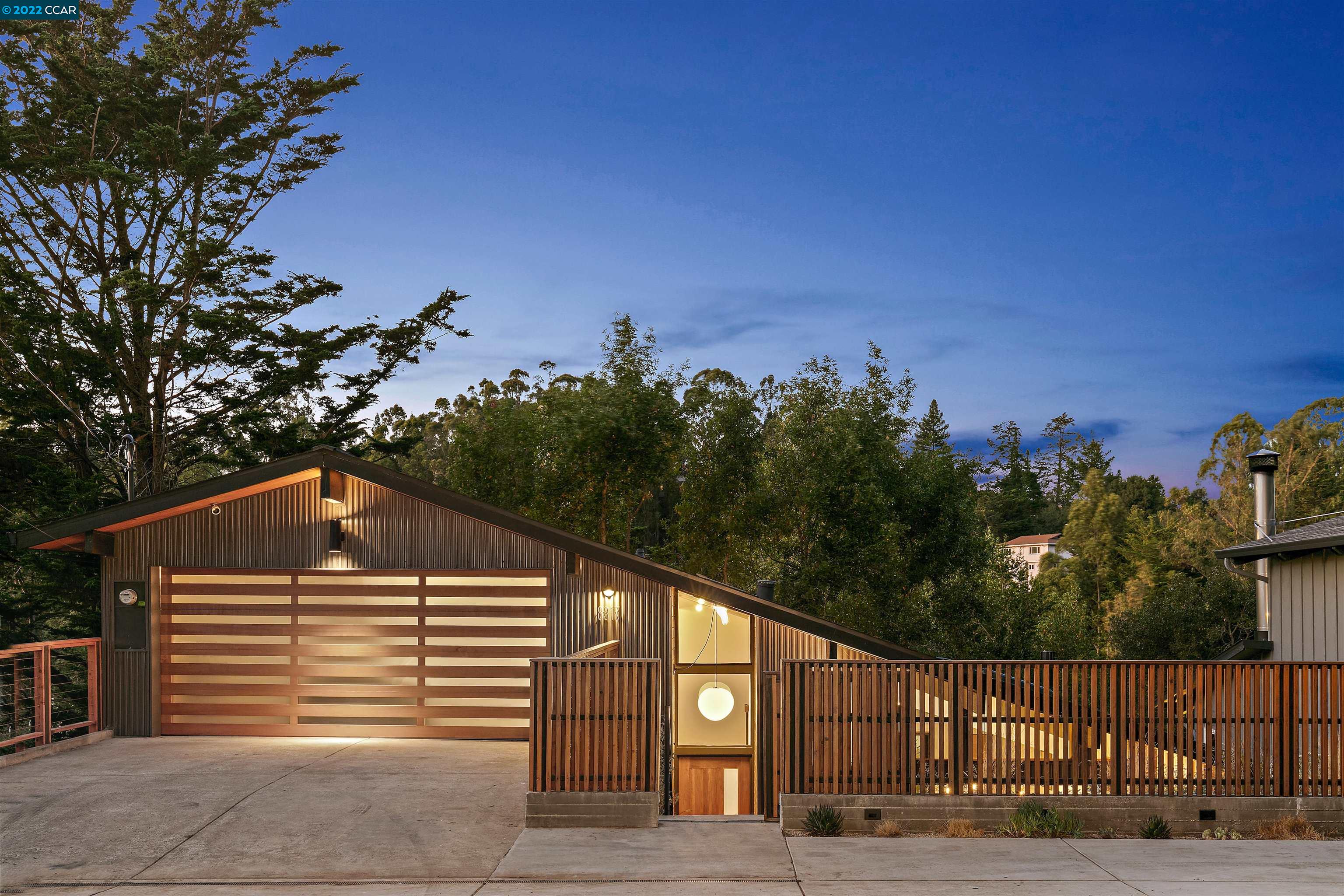 8317 Skyline Boulevard Oakland, CA 94611 - Photo 1 of 1 a view of a house next to a yard