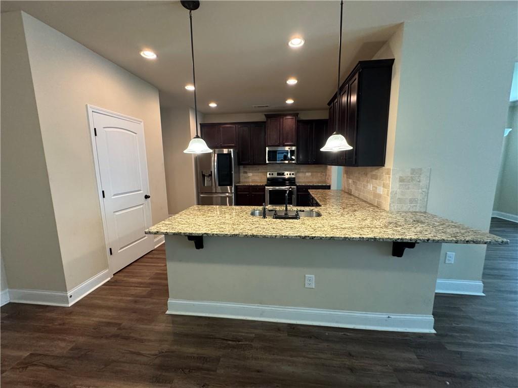 2287 Church Street Hampton, GA 30228 - Photo 3 of 11 a view of a kitchen with a sink and wooden floor