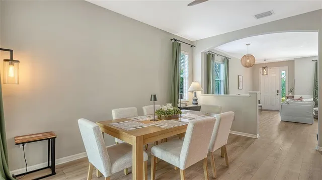a view of a dining room with furniture and wooden floor