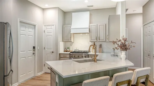 a kitchen with a table chairs and cabinets