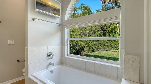 a bathroom with a tub and window