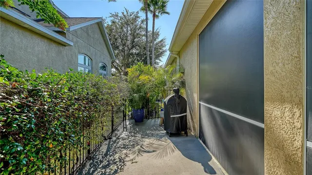 a view of a pathway of a house with wooden fence