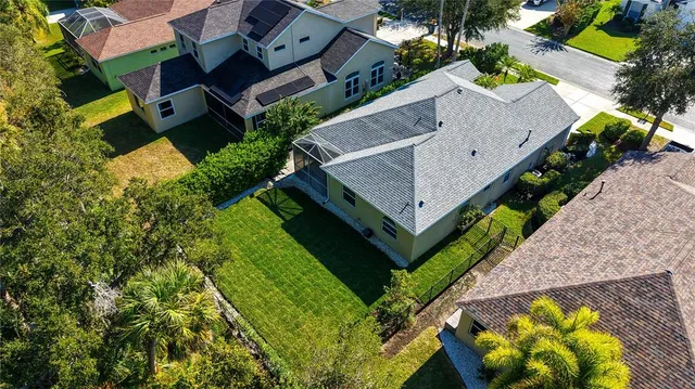 an aerial view of a house with a garden and swimming pool