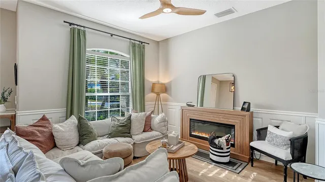 a living room with furniture and a fireplace