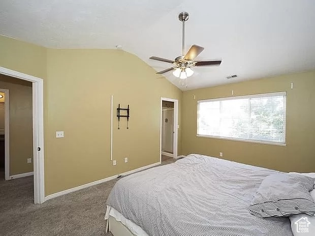 13548 South Villa Rosa Way Draper, UT 84020 - Photo 10 of 28 Vaulted ceiling with a ceiling fan, carpet flooring, a large window, and an attached full bathroom