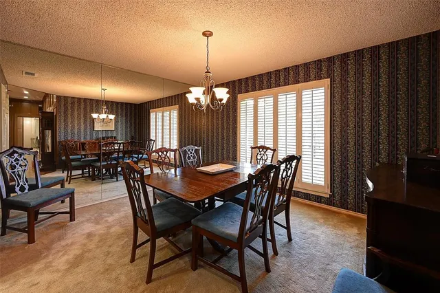 a view of a a dining room with furniture window and outside view