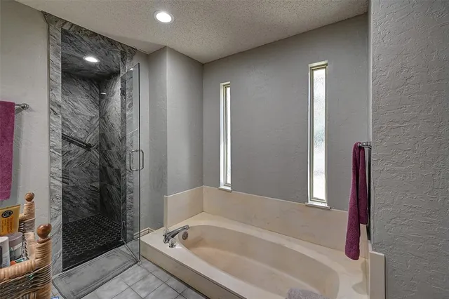 a bathroom with a bathtub and a shower