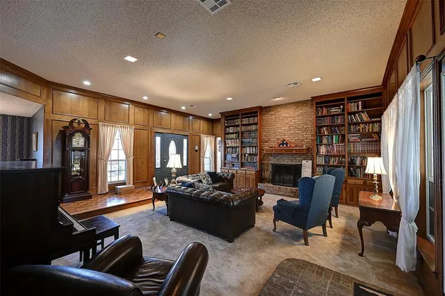 a living room with fireplace furniture and a flat screen tv