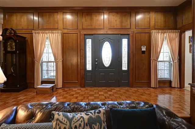 a bedroom with a large bed and a large mirror