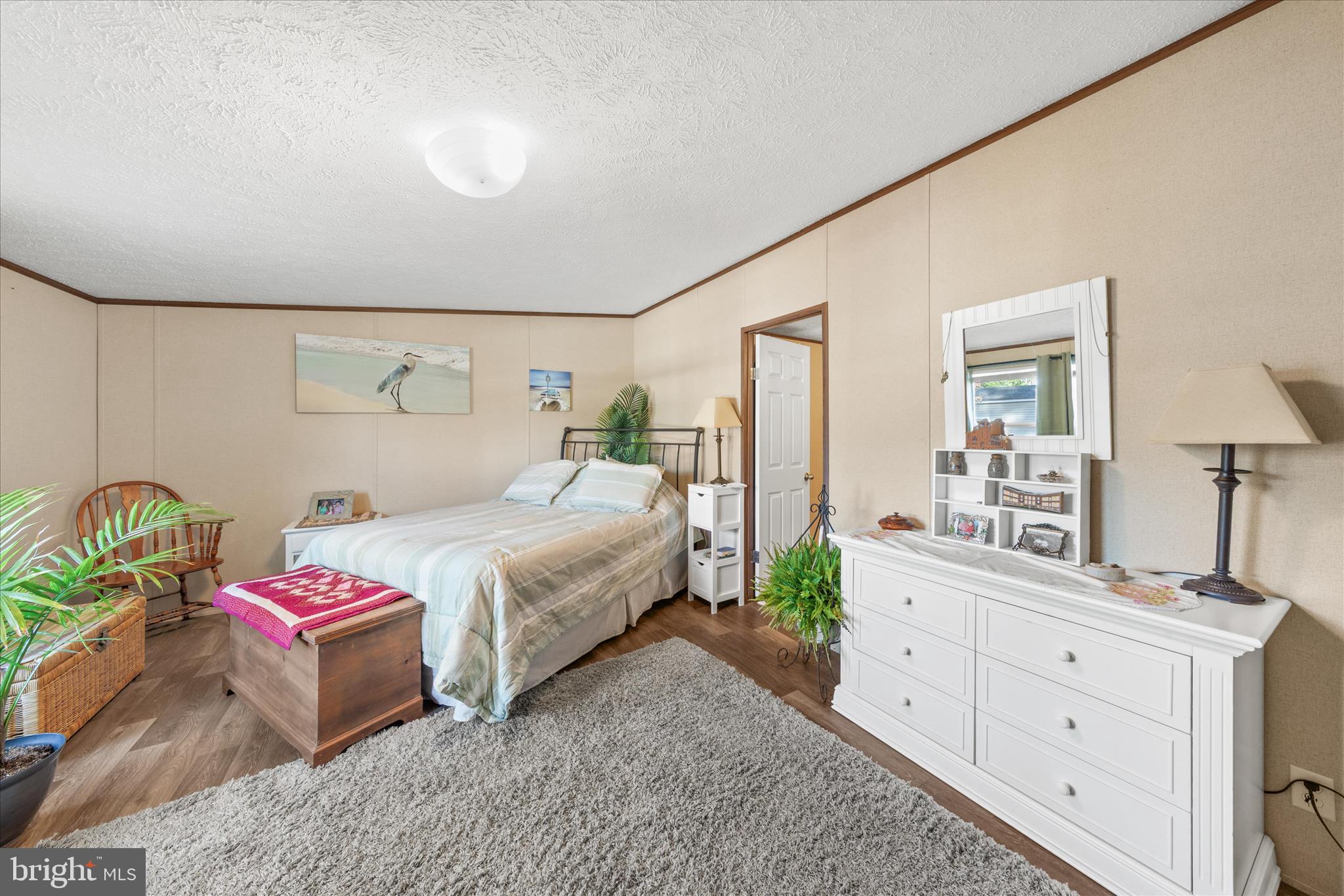 27297 Waters Edge Road Millsboro, DE 19966 - Photo 20 of 46 a bedroom with a bed and a dresser