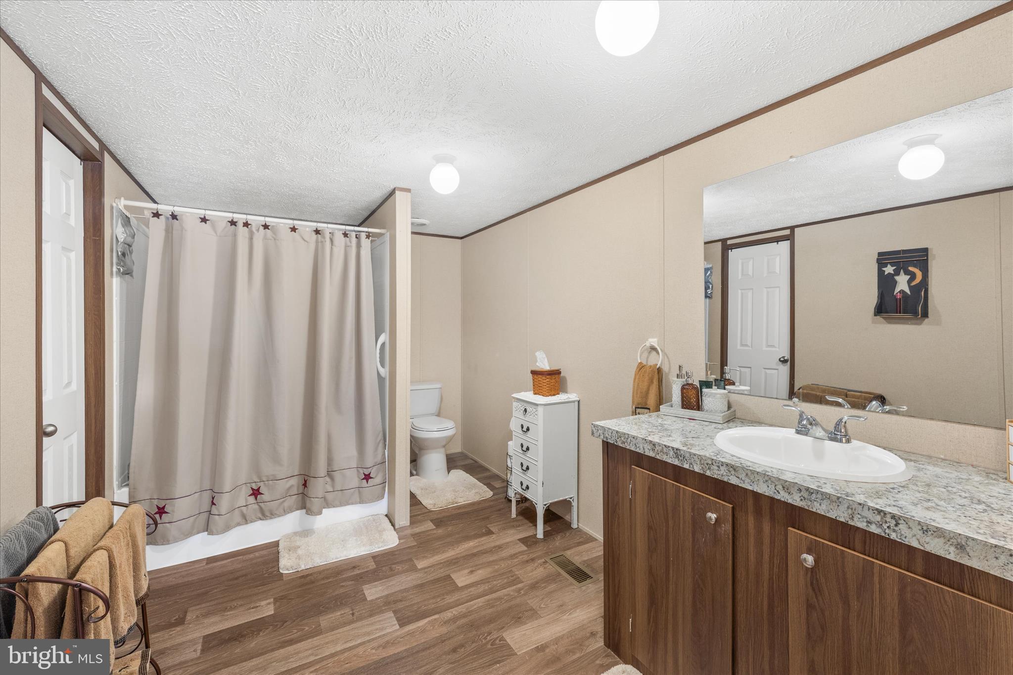 27297 Waters Edge Road Millsboro, DE 19966 - Photo 21 of 46 a bathroom with a granite countertop sink and a mirror