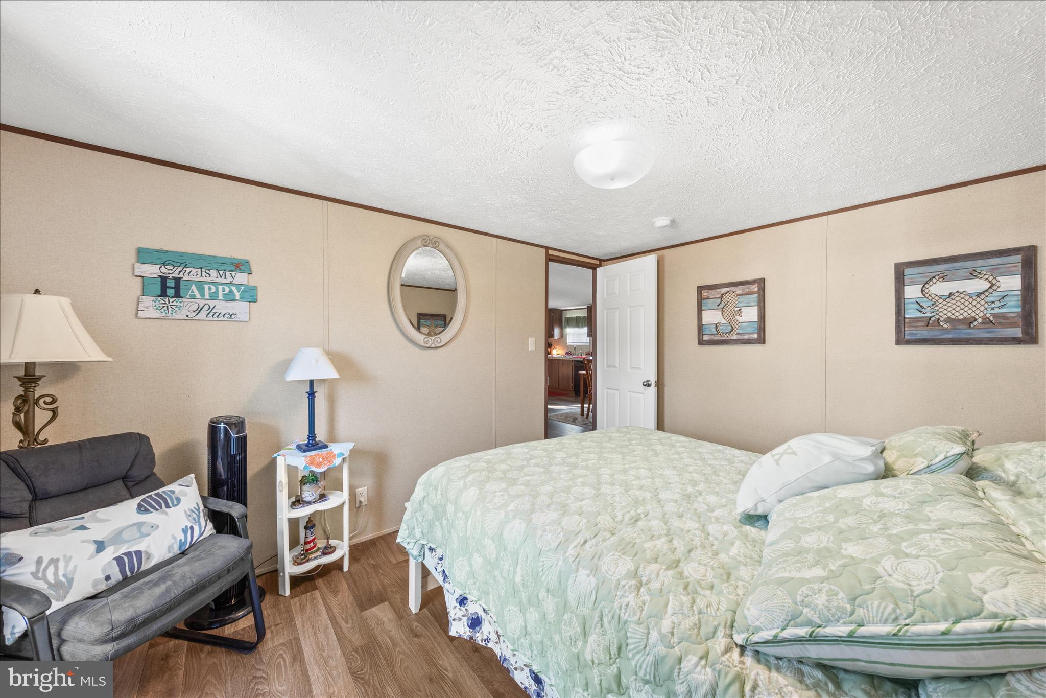 27297 Waters Edge Road Millsboro, DE 19966 - Photo 24 of 46 a bedroom with a bed and wooden floor