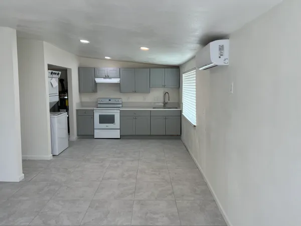 a large kitchen with a stove top oven and refrigerator