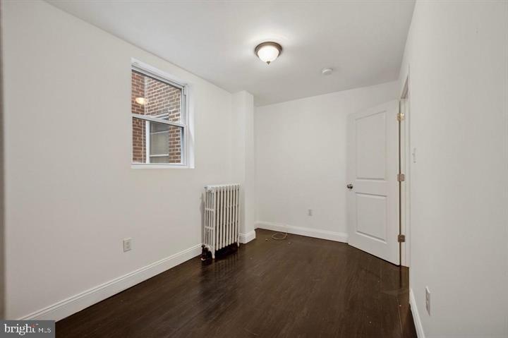 2467 79th Avenue, Unit 1 Philadelphia, PA 19150 - Photo 10 of 16 an empty room with wooden floor and windows