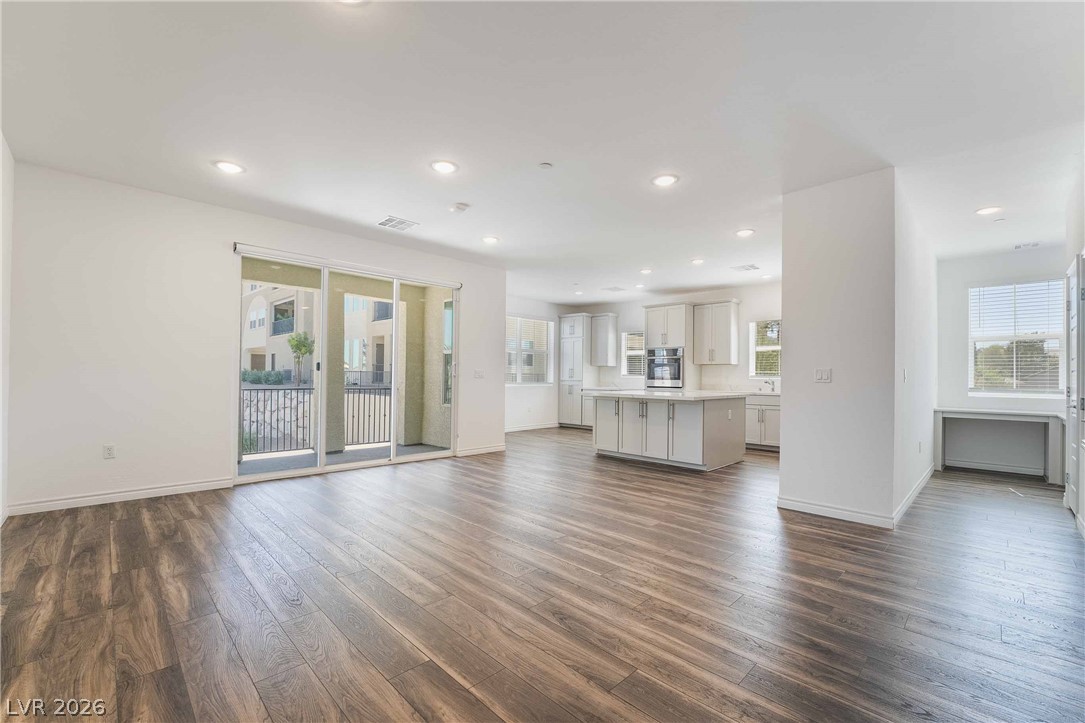 2555 Hampton Road, Unit 10202 Henderson, NV 89052 - Photo 5 of 35 Rich wood flooring flows through this airy, open-concept main level into the kitchen.
