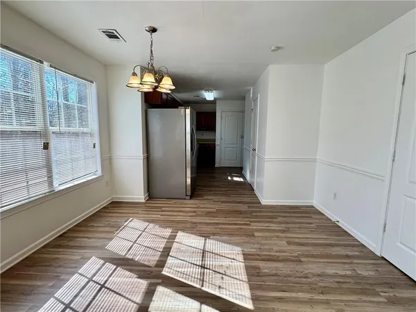 a view of a livingroom with wooden floor and a ceiling fan
