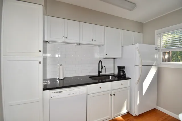 a kitchen with cabinets and white appliances