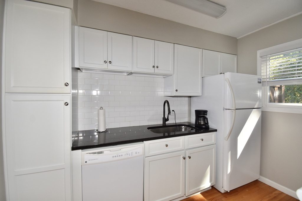 15 Yorktown Drive, Unit 15 Springfield, MA 01108 - Photo 13 of 22 a kitchen with cabinets and white appliances
