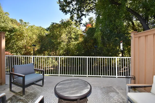 a balcony with wooden floor and fence