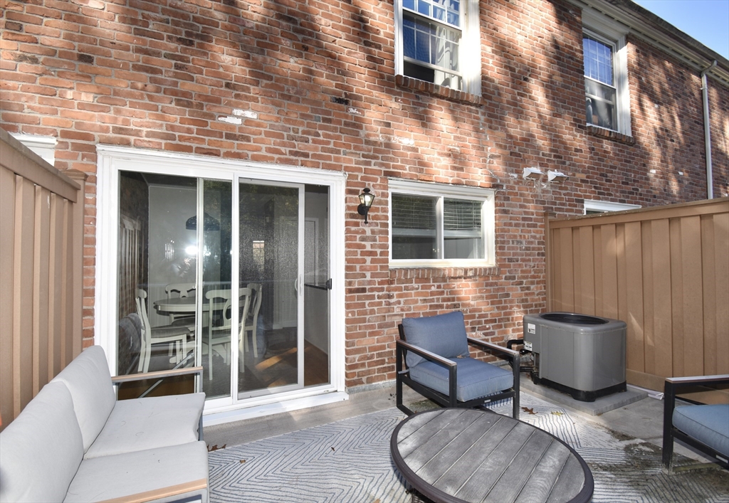 15 Yorktown Drive, Unit 15 Springfield, MA 01108 - Photo 17 of 22 a brick house with table and chairs