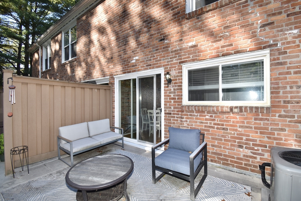 15 Yorktown Drive, Unit 15 Springfield, MA 01108 - Photo 18 of 22 a view of a patio with couches chairs and a wooden floor