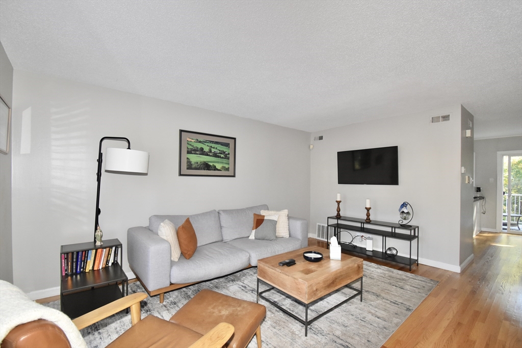 15 Yorktown Drive, Unit 15 Springfield, MA 01108 - Photo 6 of 22 a living room with furniture and a flat screen tv