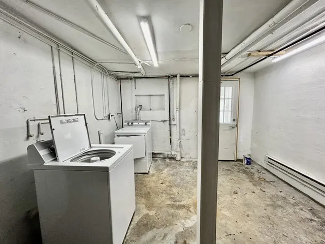 a kitchen that has a sink a refrigerator and cabinets