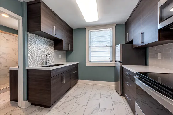 a kitchen with a sink stove and microwave