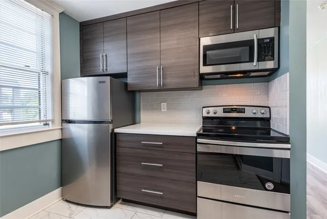 a kitchen with appliances and cabinets