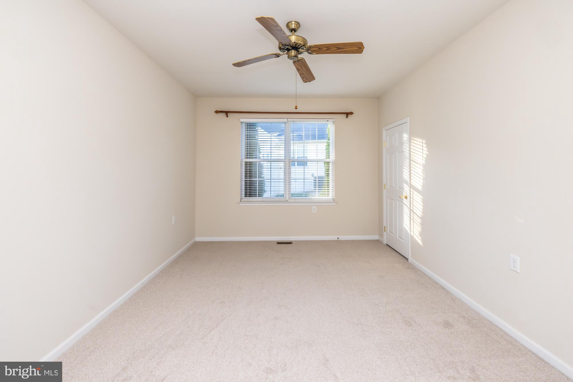 209 Kendig Road Coatesville, PA 19320 - Photo 17 of 47 an empty room with a window and a ceiling fan