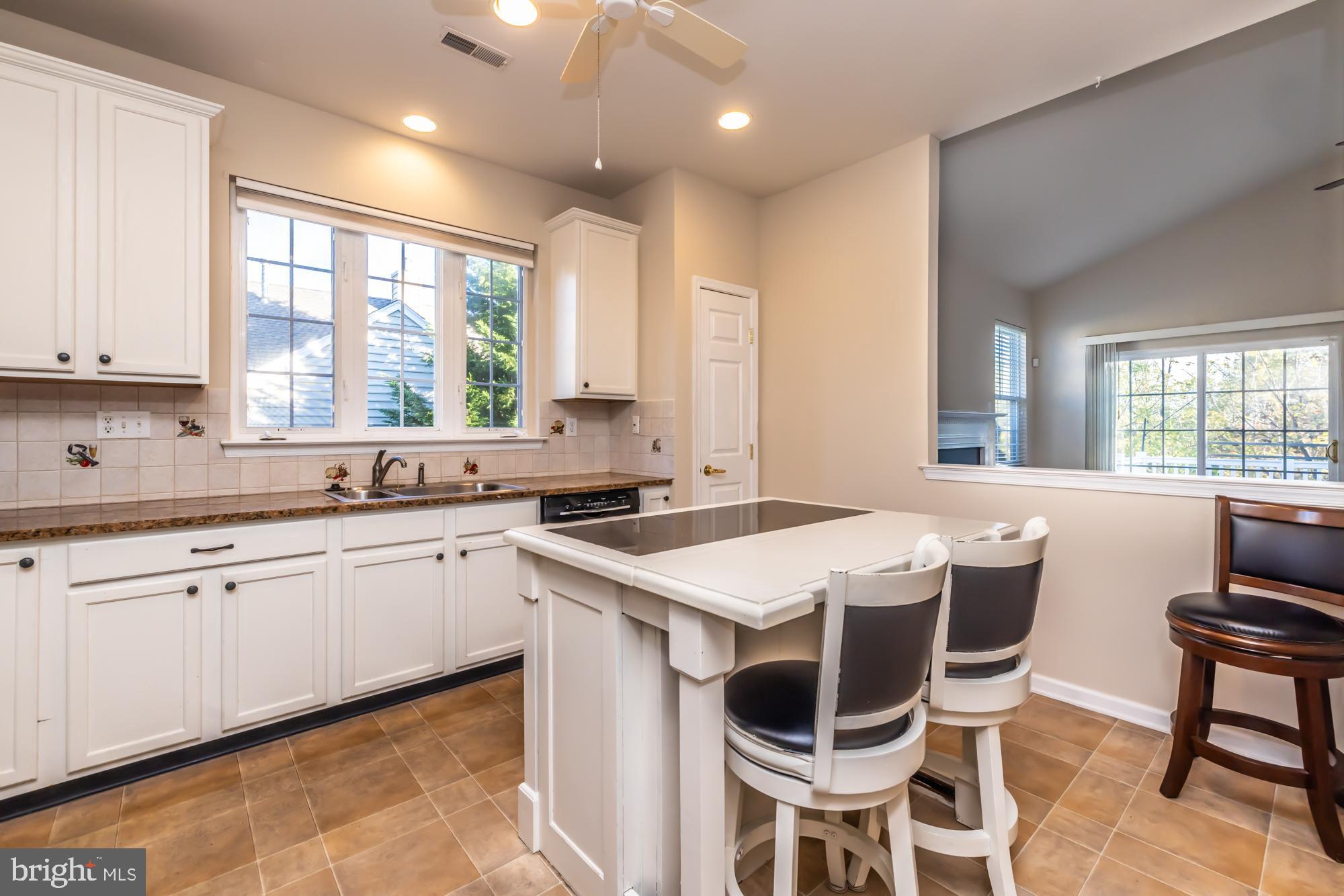 209 Kendig Road Coatesville, PA 19320 - Photo 2 of 47 a kitchen with a stove a sink and white cabinets with wooden floor