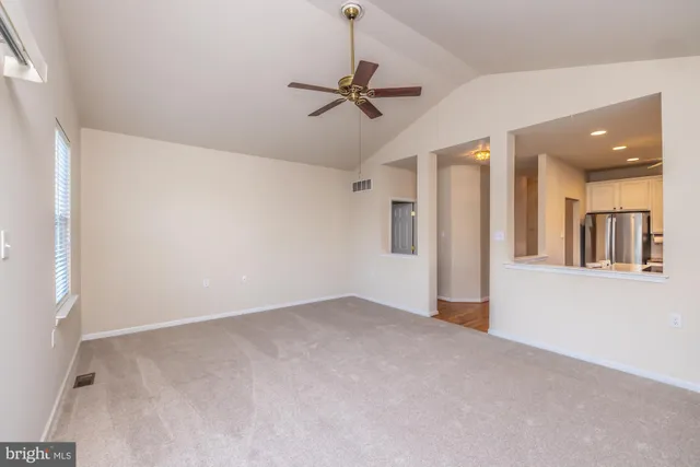 an empty room with fan and entrance