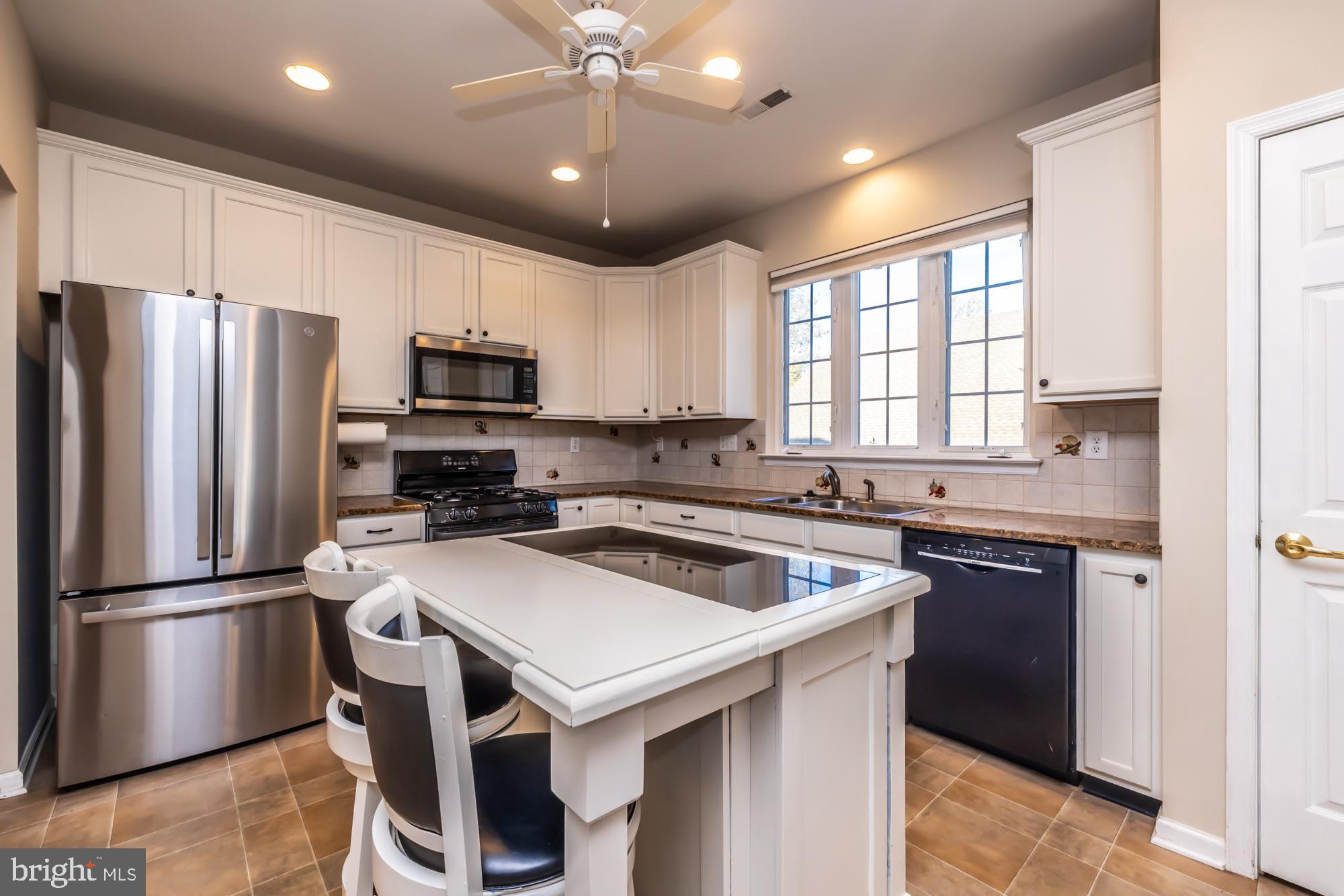 209 Kendig Road Coatesville, PA 19320 - Photo 3 of 47 a kitchen with a stove a sink and a refrigerator
